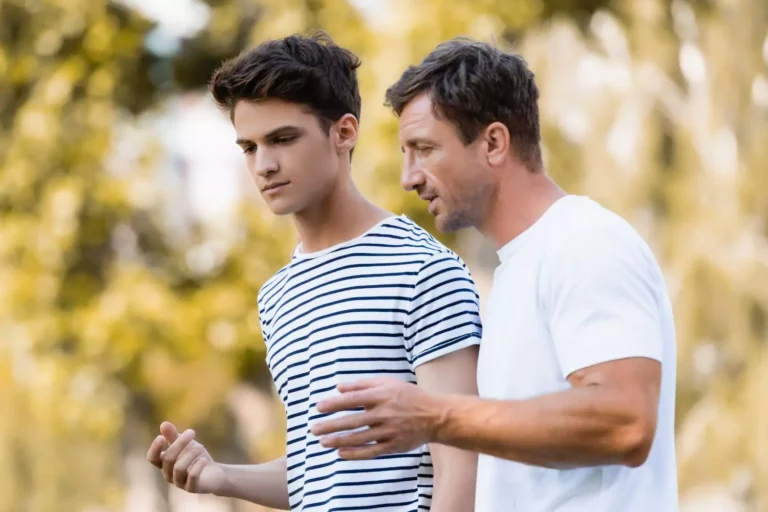 This is relentless parenting- a father walking with his arm around his teen son, giving him encouragement