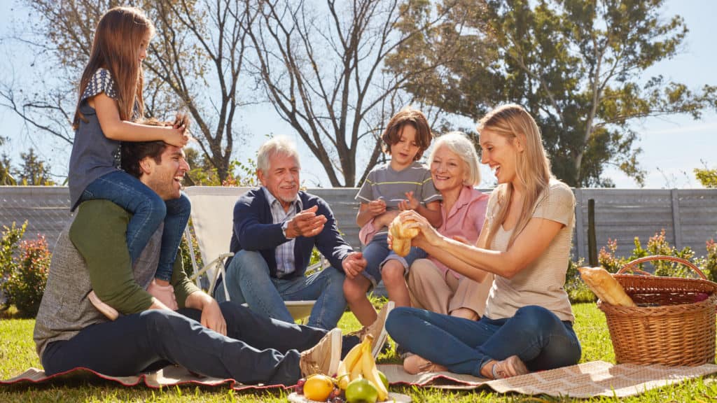 extended family enjoying picnic in backyard