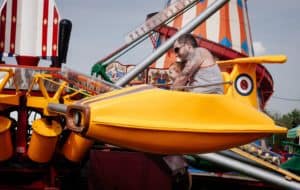 dad and son riding amusement park ride together