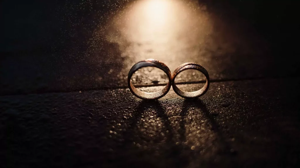 photo of two wedding rings standing in the rain with industrial lighting. Know the truth about your spouse.