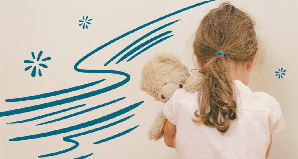 Girl holding teddy bear and facing the wall as she is disciplined