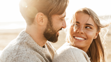 Young couple smiling in sunlight