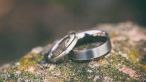 two silver rings on mossy rock