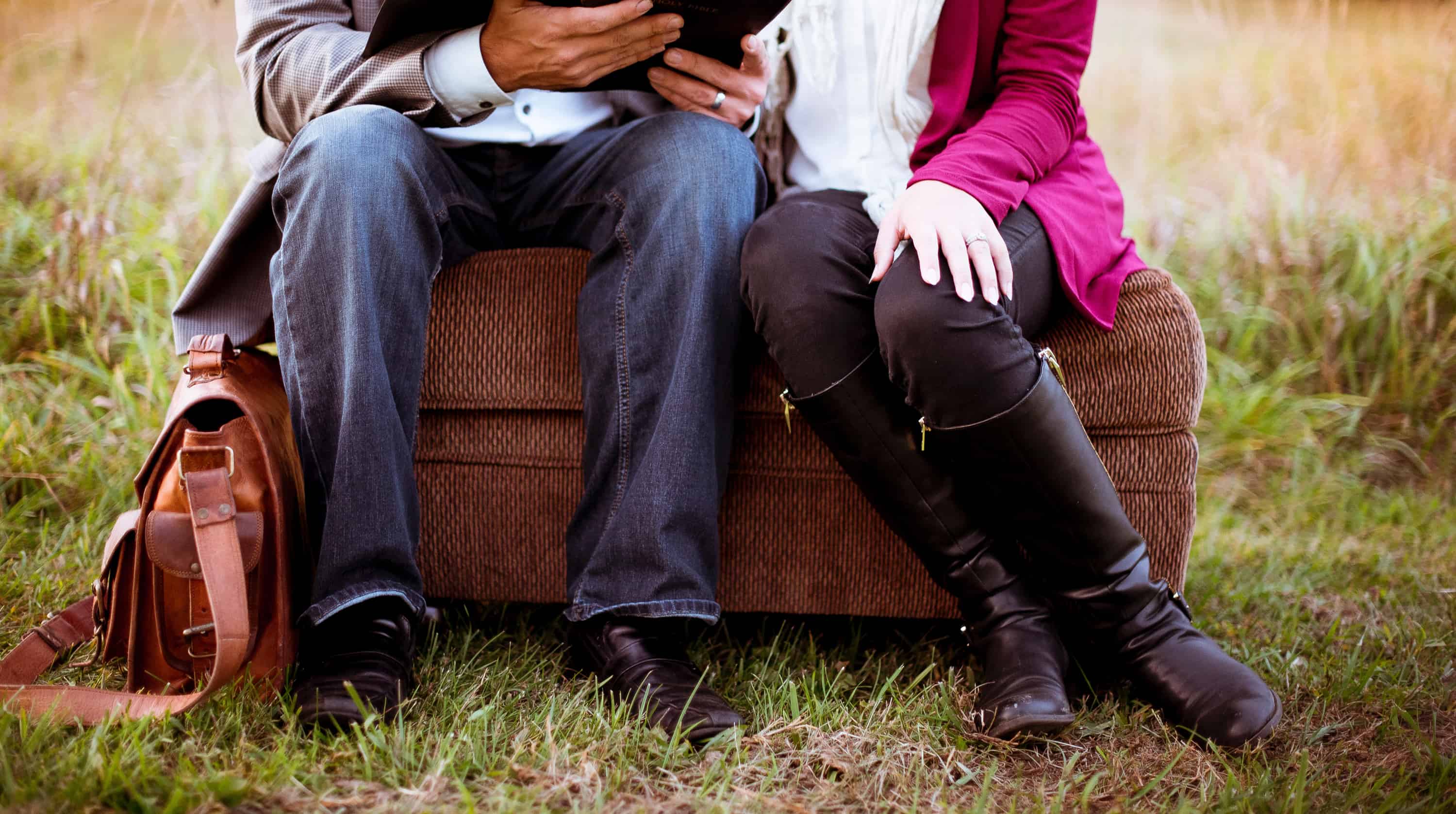 A couple sits together reading the Bible