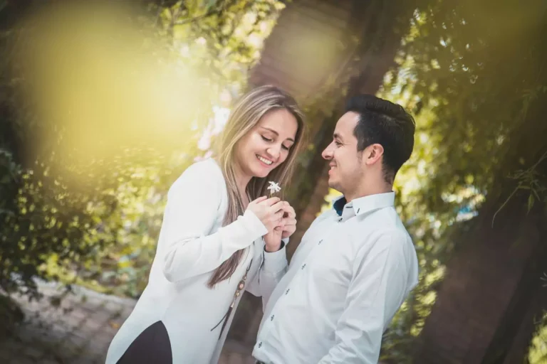 Taking the first year off in marriage — a joyful newlywed couple shares a sweet moment outdoors, smiling and enjoying each other’s company.