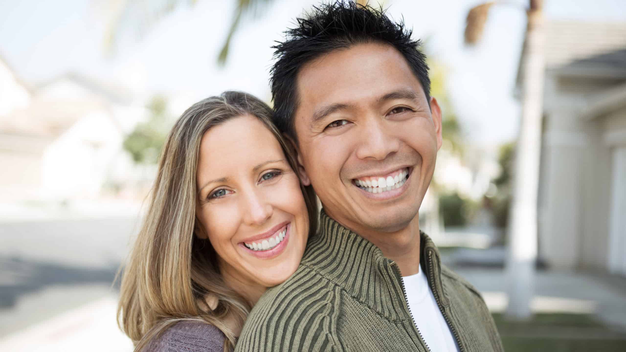interracial couple smiling at camera