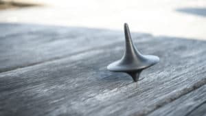 black gyroscope spinning atop table