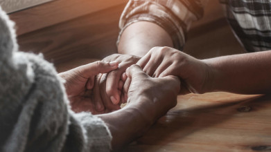 When Two Pray - A couple holds hands and prays together