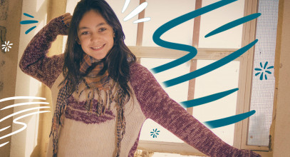 Stylized image of smiling tween girl posing for the camera, showing off her knit winter sweater