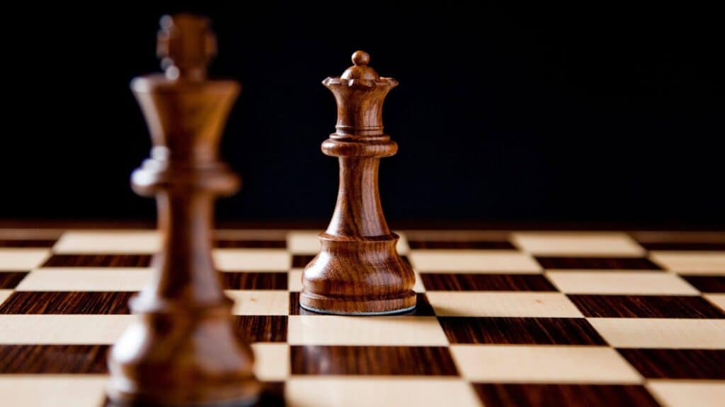 Communication and conflict are key points in marriage and are both valuable. Couples in conflict often think they are fighting against each other, but really they are on the same side. This image is of two chess pieces, a king and queen on opposite sides of the board, but still on the same team.