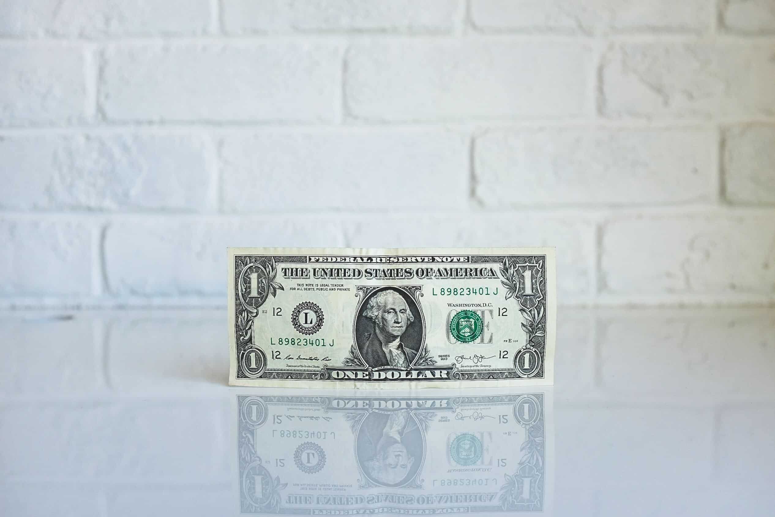 $1 US banknote on white surface