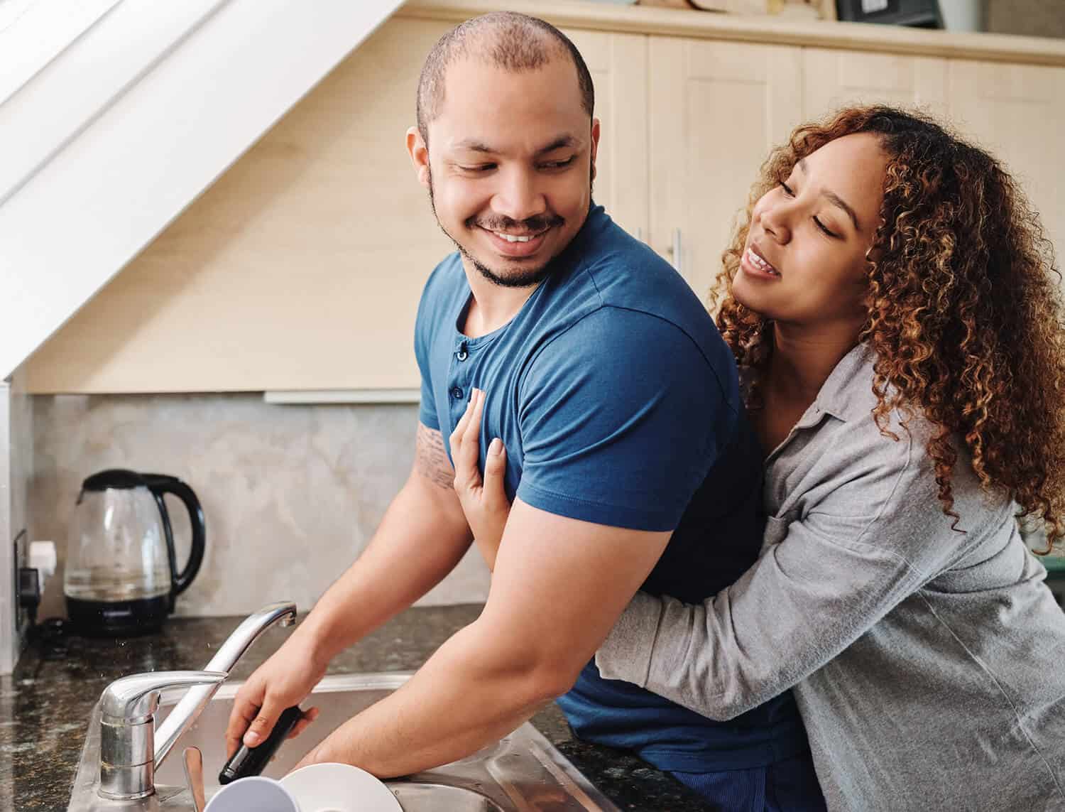 Couple doing dishes together showing agape love in marriage