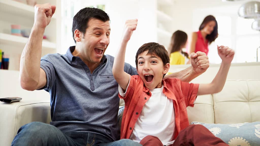 dad and son with arms in the air and mother and daughter are behind them - teaching character