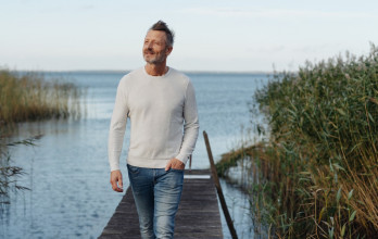 Middle age man enjoying a walk on a pier