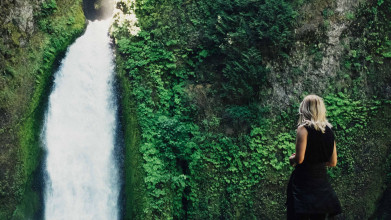 woman in front of waterfall