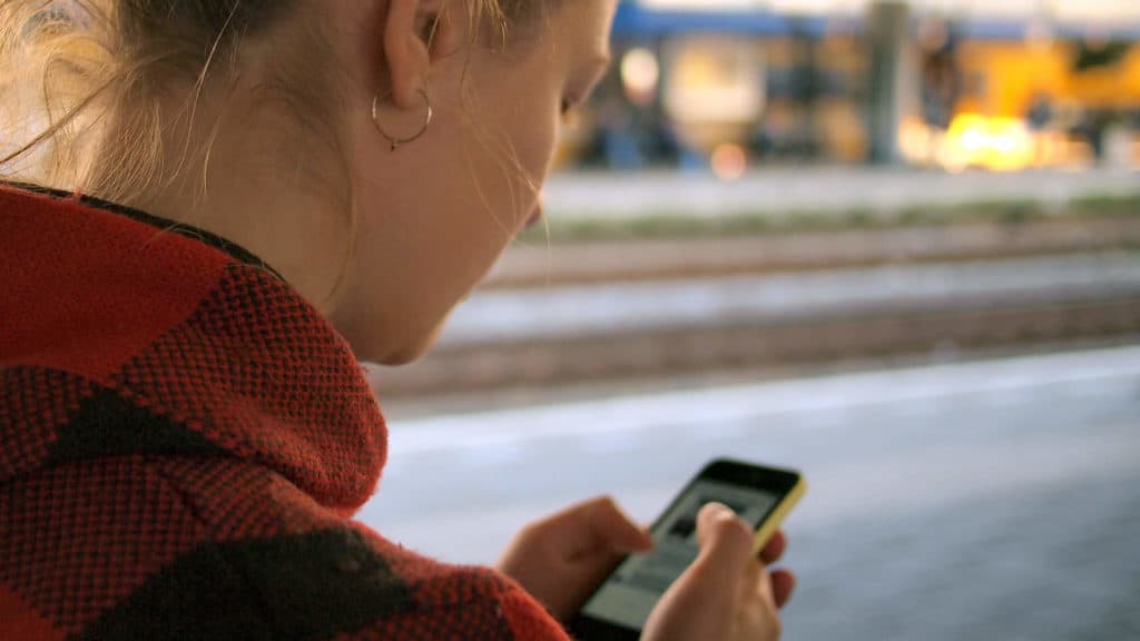 A woman checks her smartphone