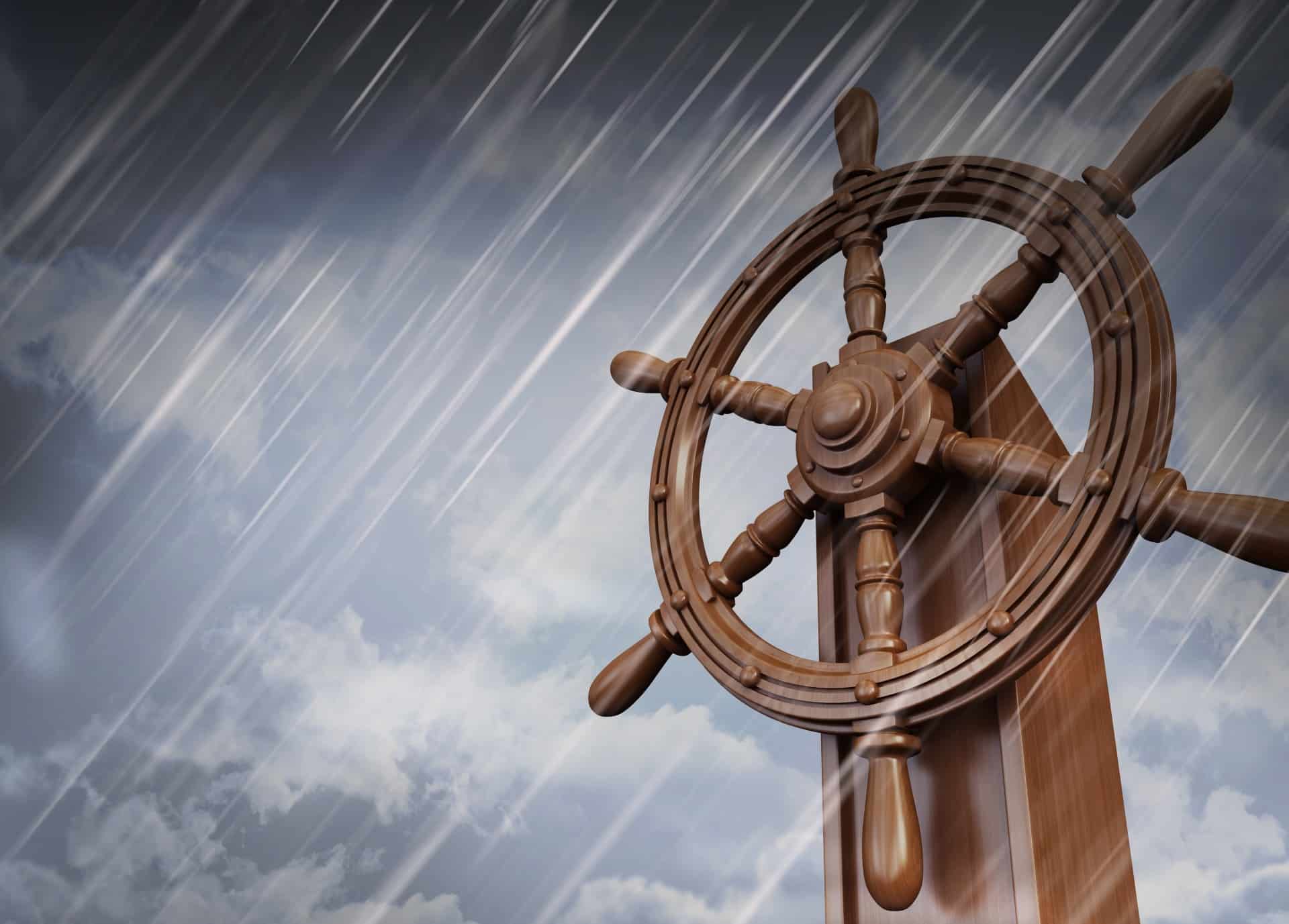 Close-up of a ship's helm in stormy, rainy weather