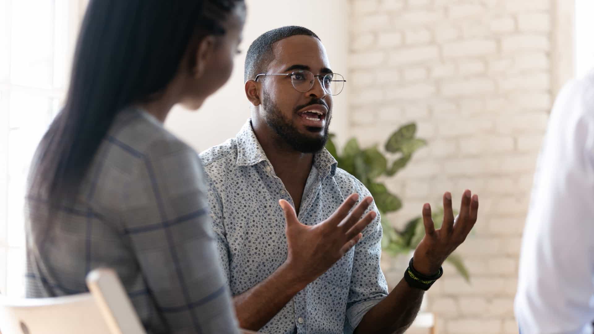 African-American man sharing his feelings in a group counseling discussion