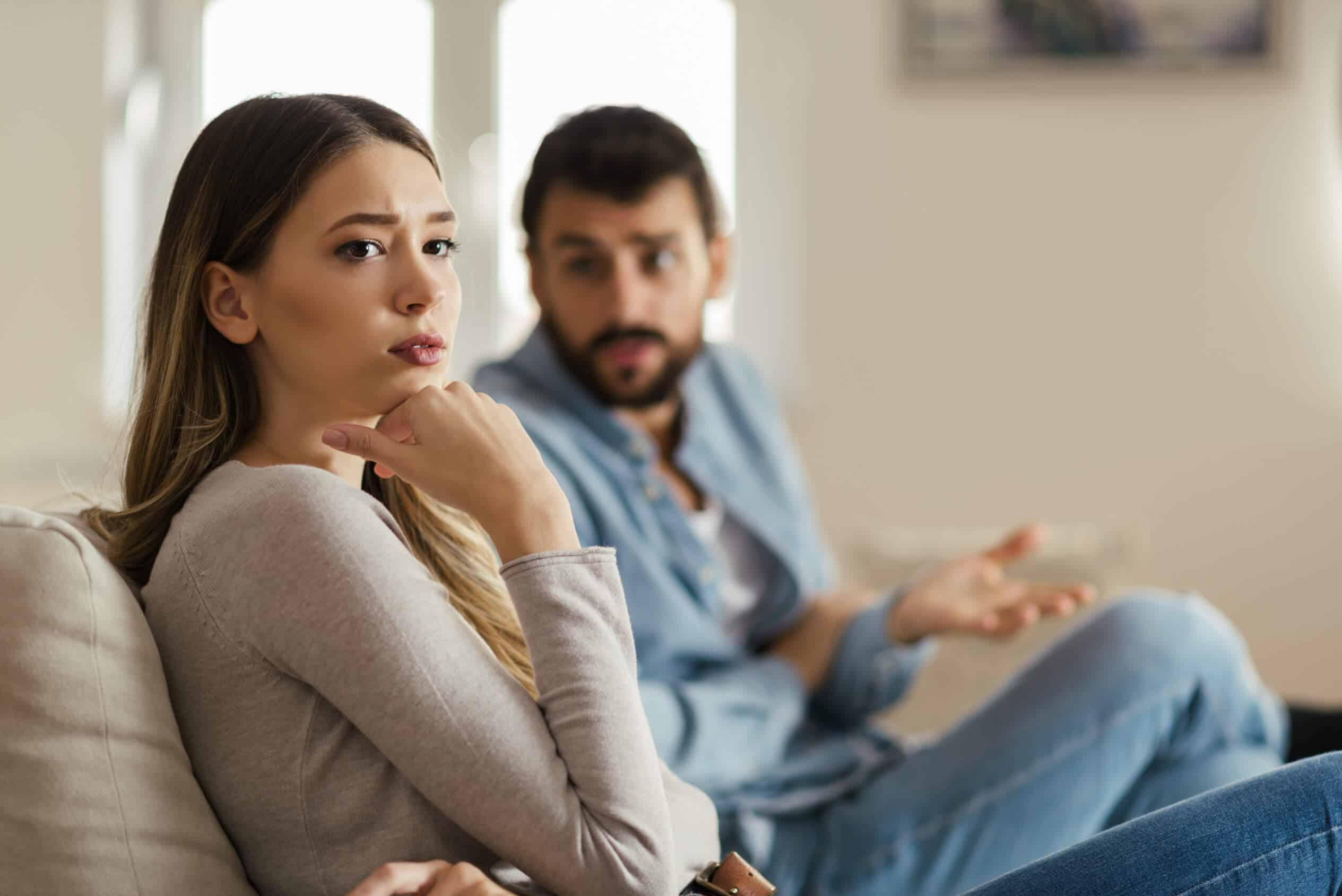 a woman looks worried as a man talks to her