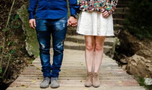 A couple holding hands on an outdoor trail