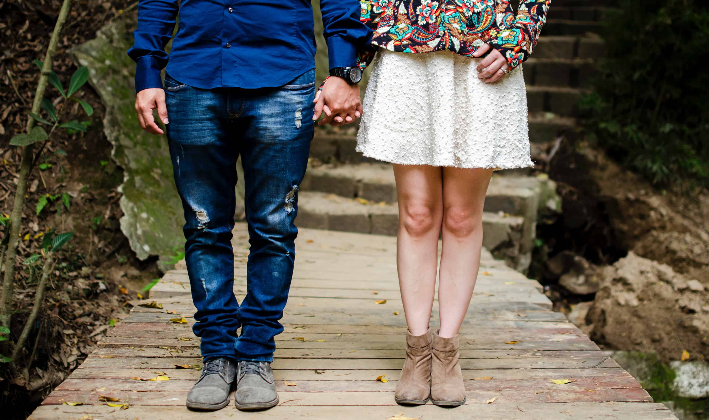 A couple holding hands on an outdoor trail