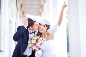 A young married couple celebrates their wedding. Studies show the best age to marry is between the lower to mid 20s.