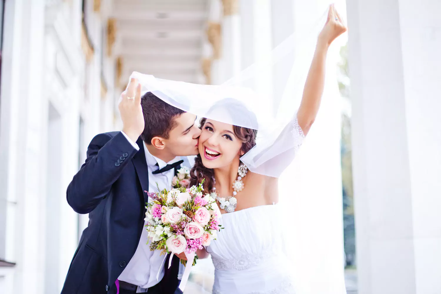 A young married couple celebrates their wedding. Studies show the best age to marry is between the lower to mid 20s.