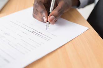 A man about to sign a contract
