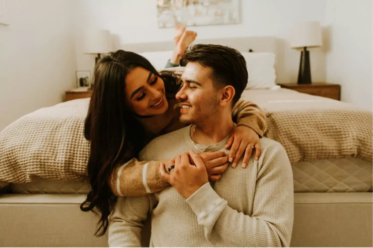 A couple shares a tender moment in their bedroom, symbolizing rekindling sexual intimacy in marriage through connection and closeness.