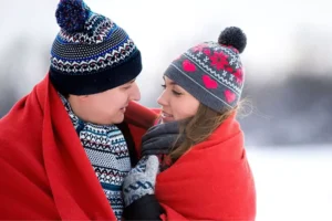 A cozy winter moment illustrating closeness between a husband and wife who have been reading daily devotions for married couples.