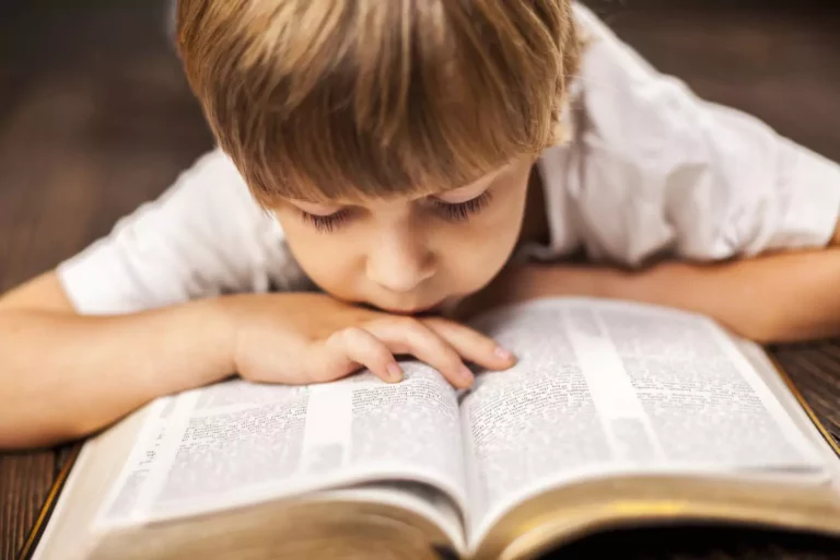 Little boy reading his Bible