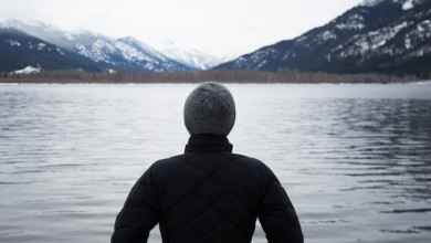 man standing in front of lak