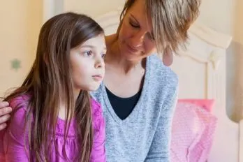 Mom looking to her school-age daughter