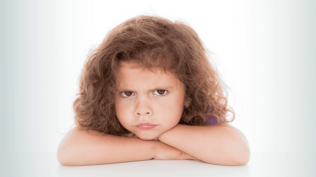 boundaries for kids, little girl with her arms folded pouting