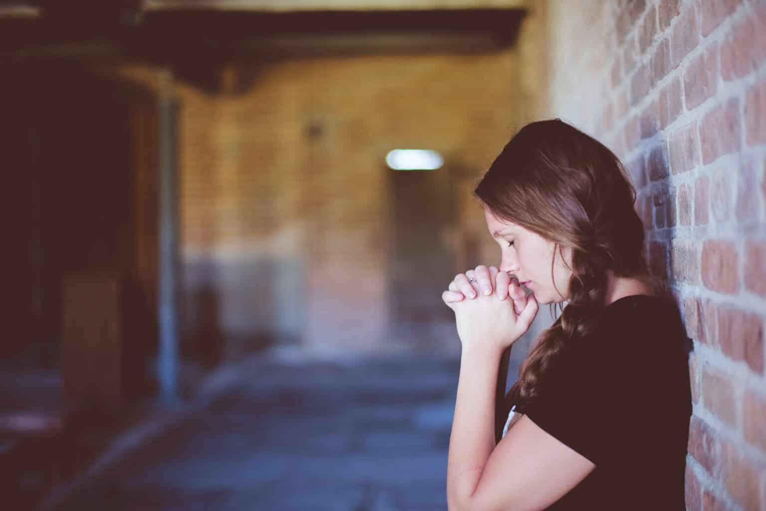 AnxiousWomanPrayingAgainstWall-1536x1025.jpg