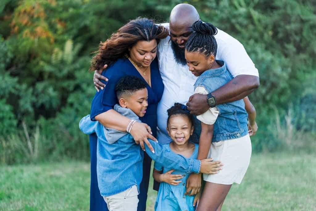 Dad hugging family