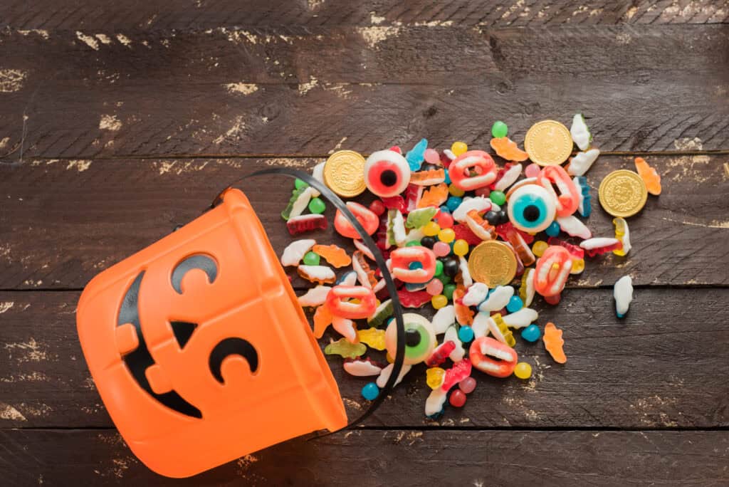 pumpkin bucket with candy spilling out