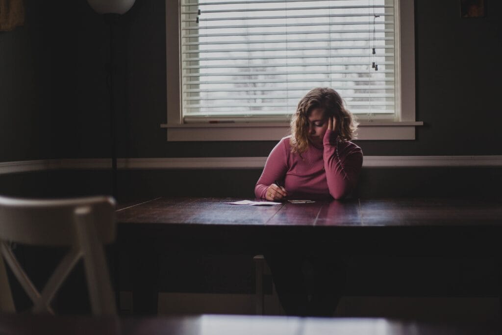 woman sitting at desk in darkness