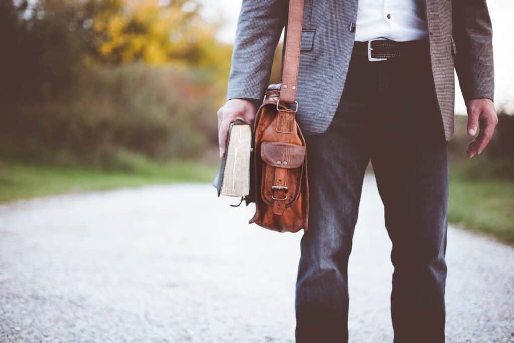 man with satchel and Bible