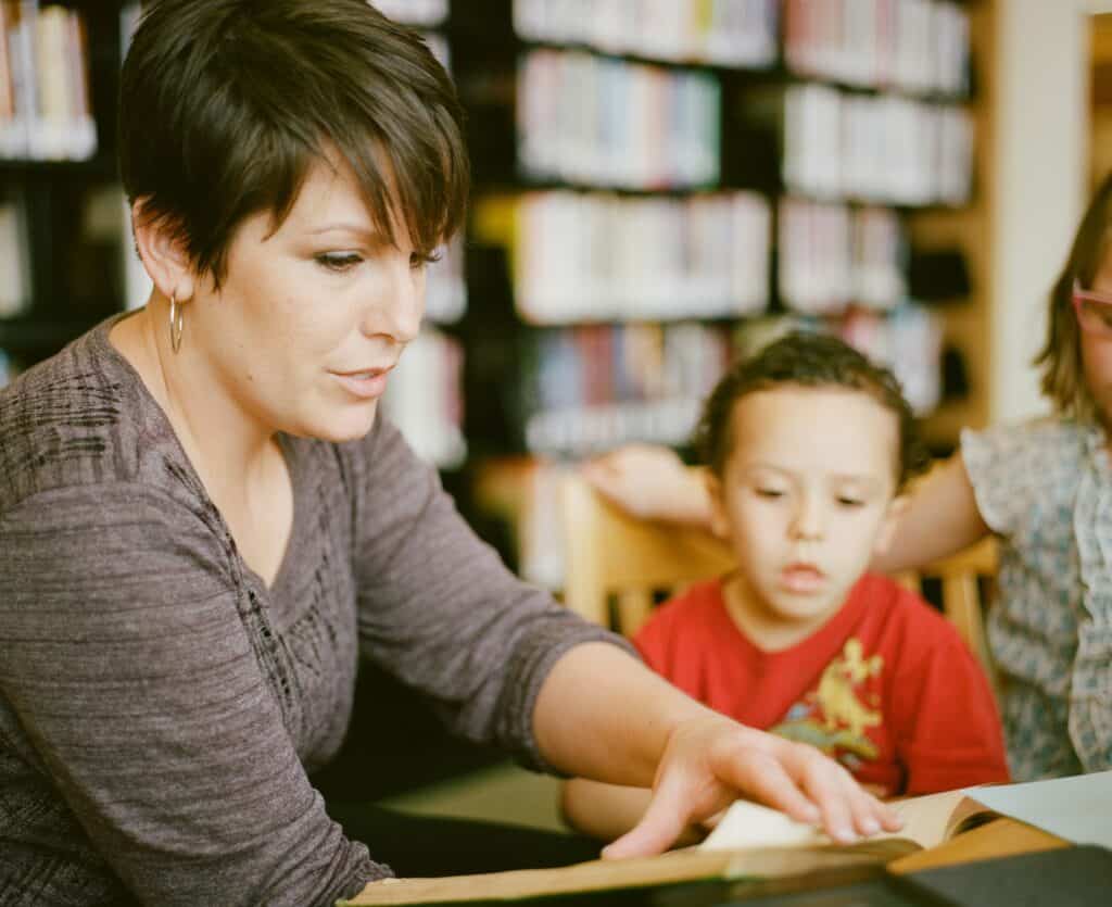 Teacher reading with young boy