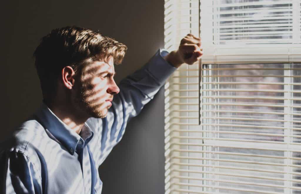 adult young man staring out window