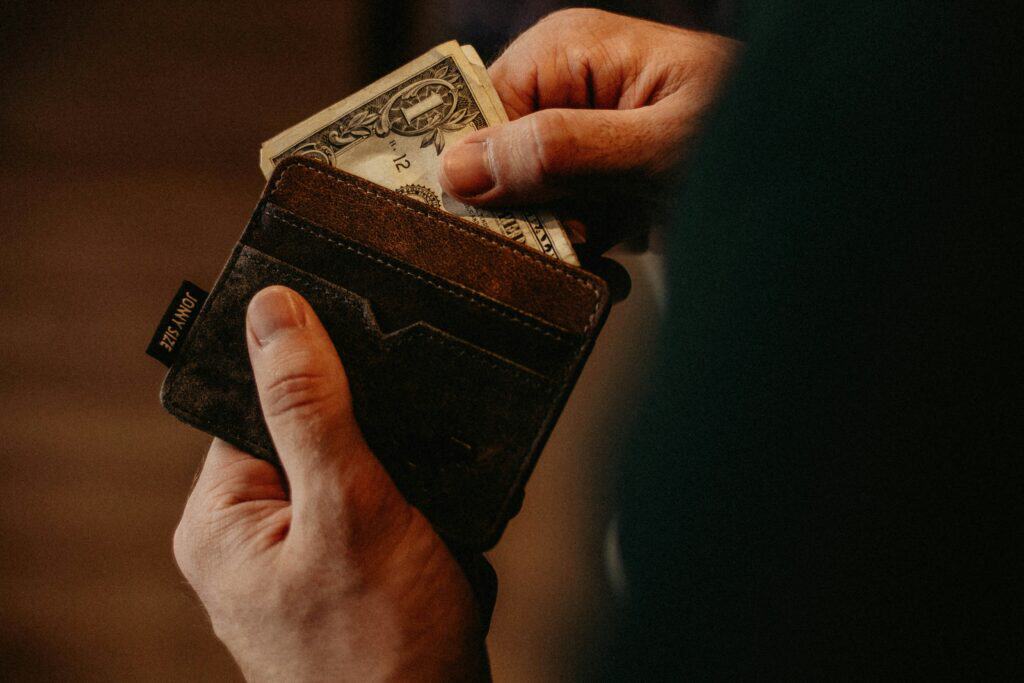 hand pulling money out of wallet