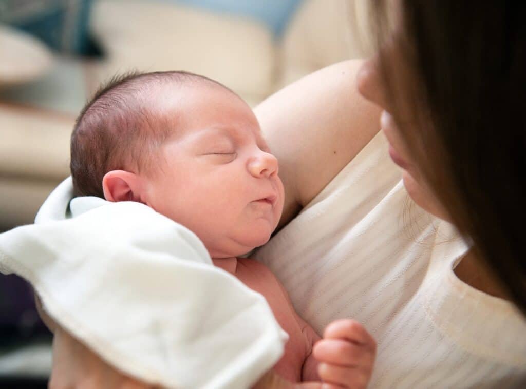 mother holding sleeping baby