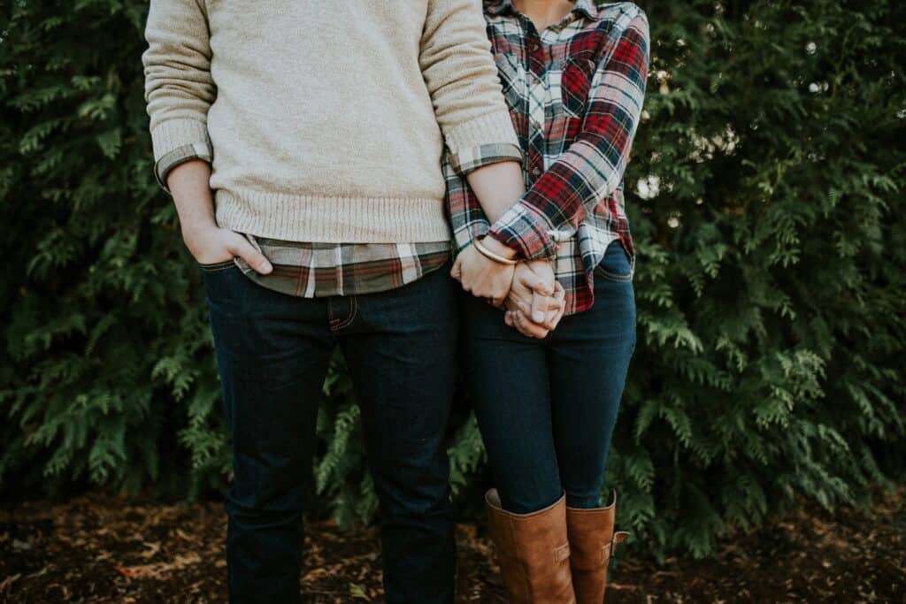 man and woman holding hands no faces