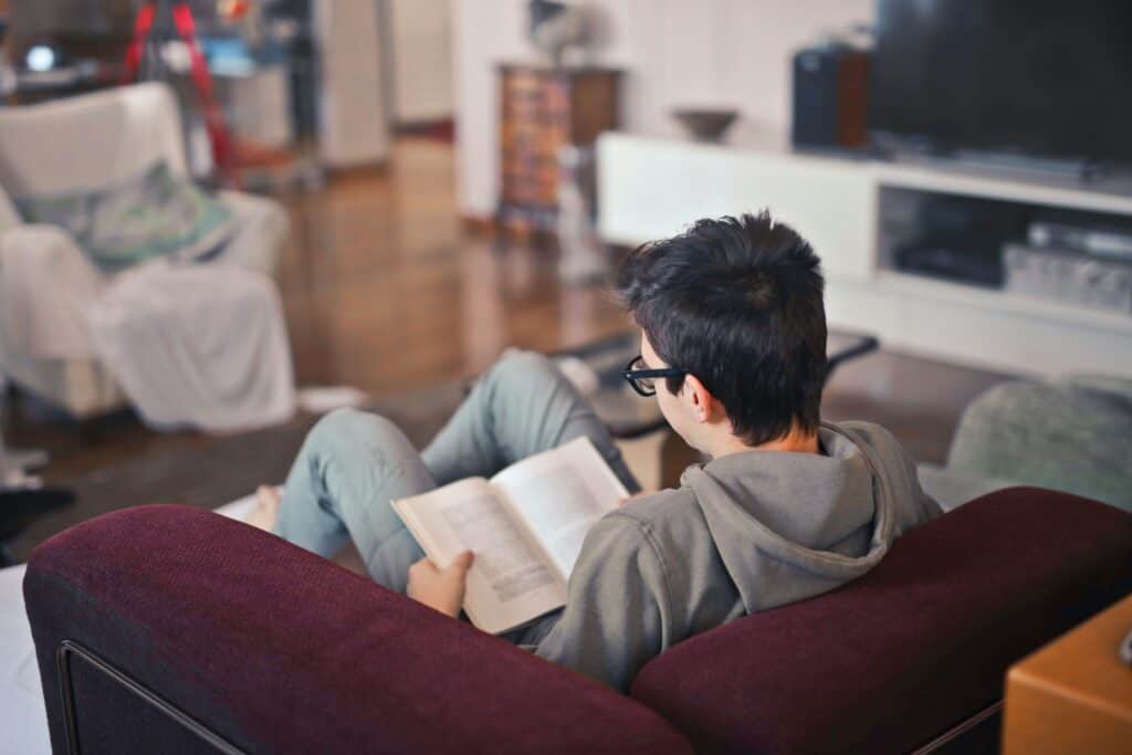 teen boy reading book