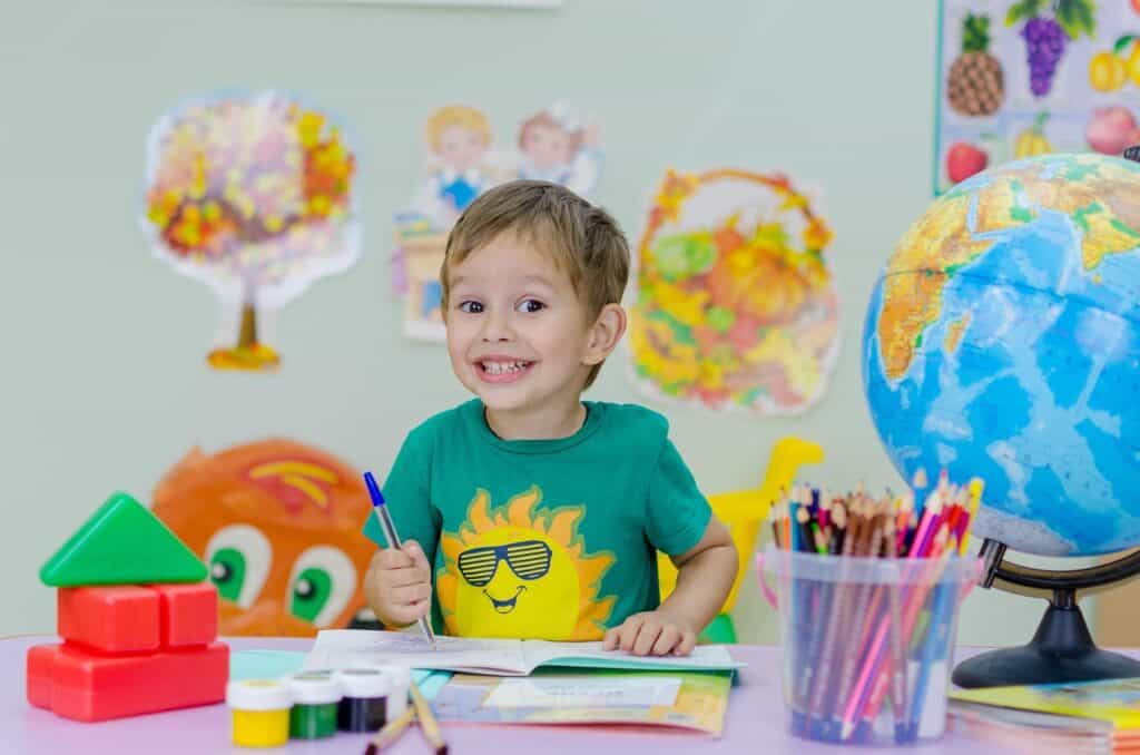 grinning child in a classroom