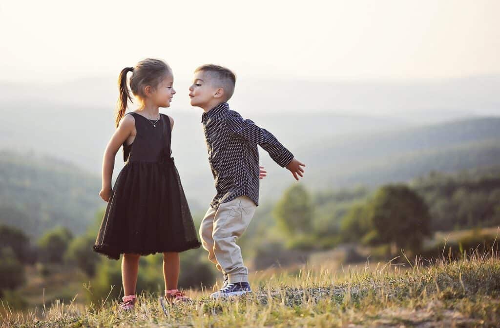 young boy and girl in field