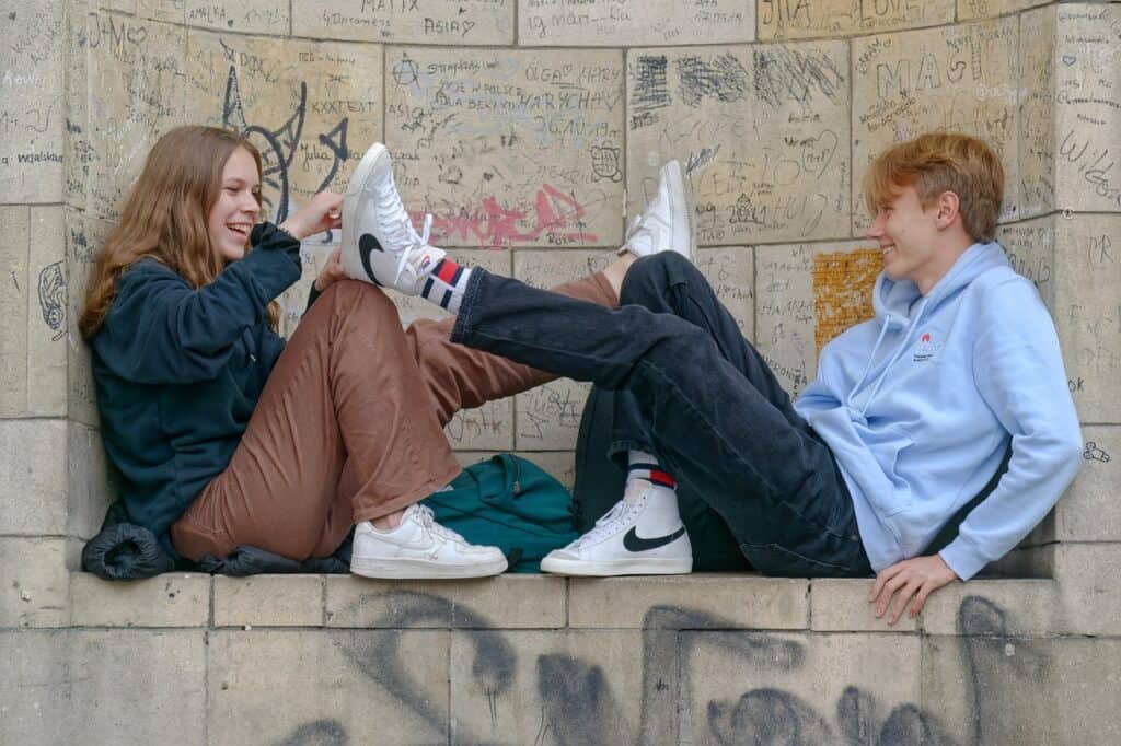 boy and girl goofing off on ledge