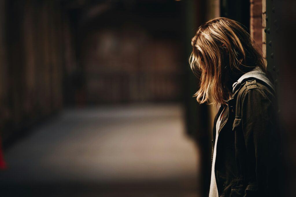 woman head bowed in despair