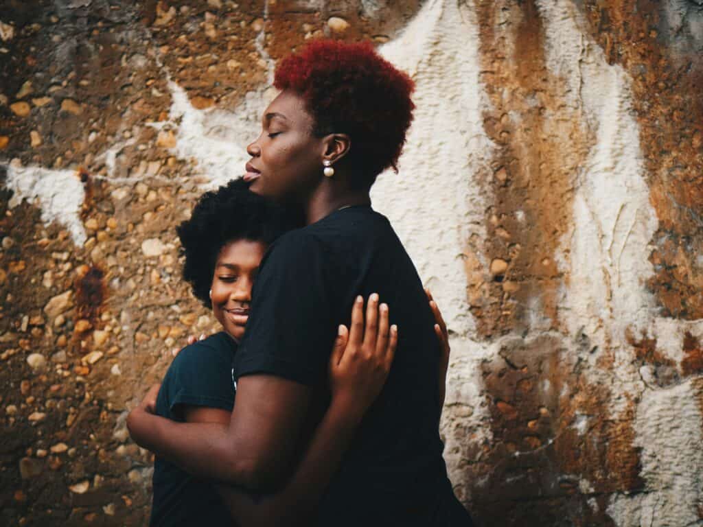 mom and teen hugging